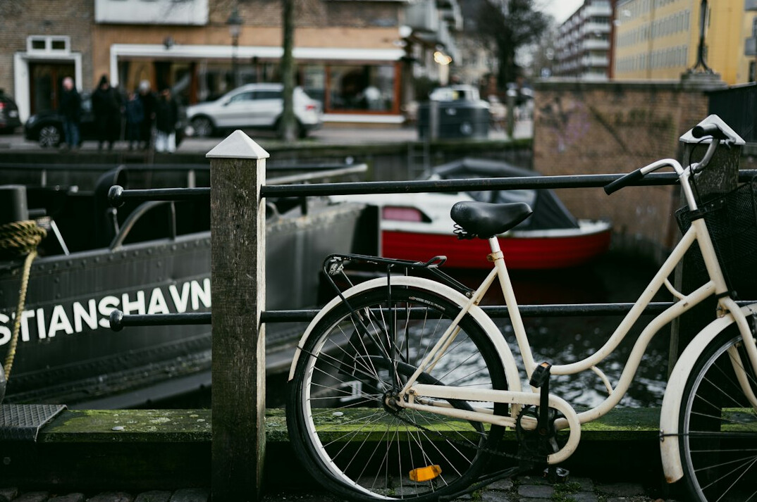 Bicycles parked along a Danish canal in the evening light